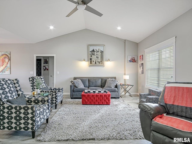 living room featuring baseboards, lofted ceiling, a ceiling fan, and wood finished floors