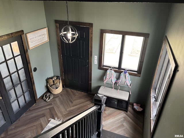 entryway with a chandelier