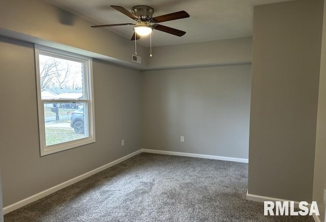 carpeted empty room with ceiling fan and baseboards