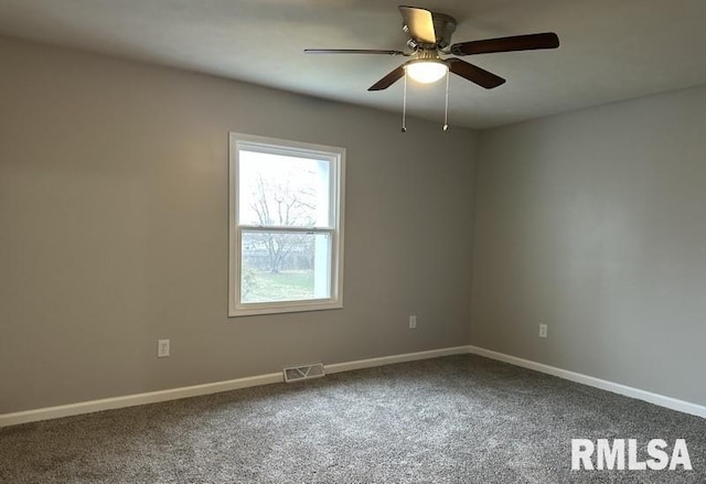 empty room with carpet flooring, baseboards, visible vents, and ceiling fan