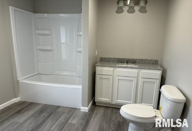full bath with toilet, vanity, baseboards, and wood finished floors