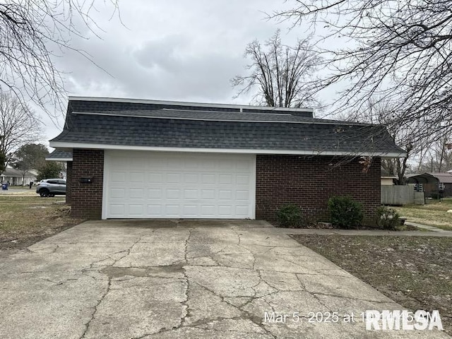 garage with concrete driveway