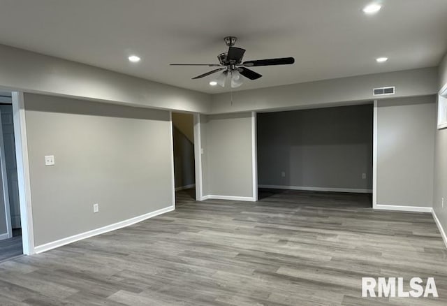 basement featuring recessed lighting, wood finished floors, visible vents, and ceiling fan