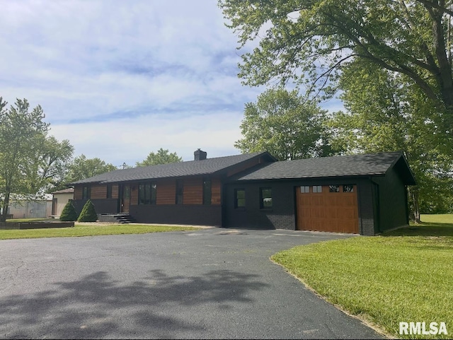 15563 State Highway 149, West Frankfort, IL 62896 - view of front facade with an attached garage, asphalt driveway, a front yard, and a chimney