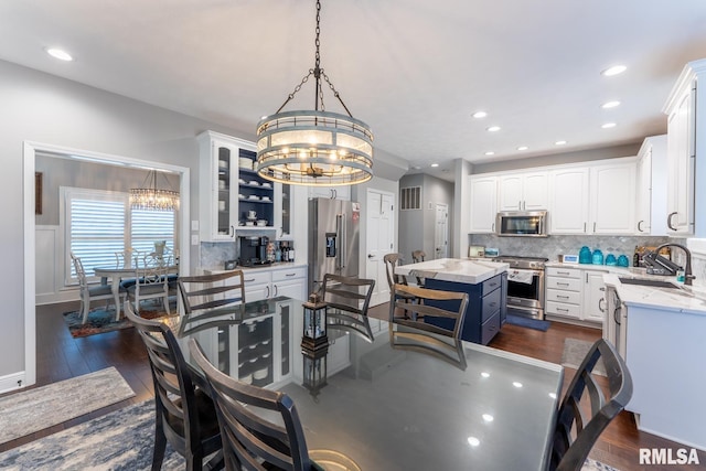 dining room featuring an inviting chandelier, recessed lighting, and dark wood-style flooring