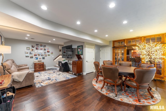 dining space with recessed lighting, stairway, baseboards, and wood finished floors