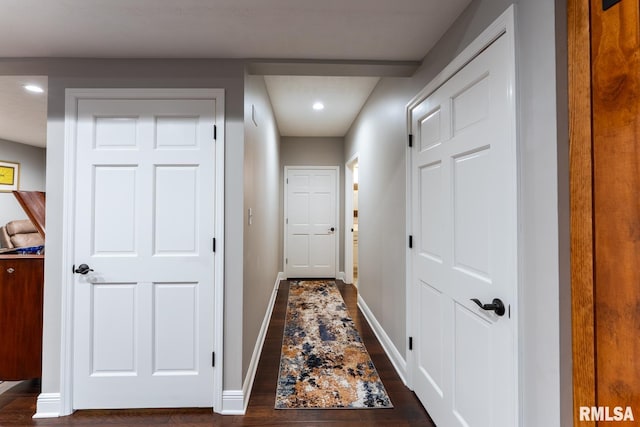 hallway featuring dark wood-style floors, recessed lighting, and baseboards