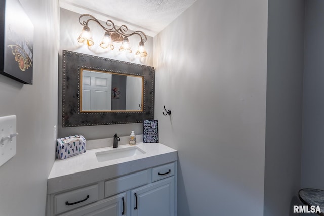 bathroom featuring a textured ceiling and vanity