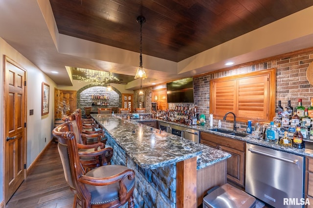 bar with a sink, a raised ceiling, dishwasher, and wooden ceiling