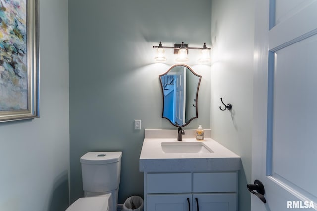 half bath featuring toilet and vanity