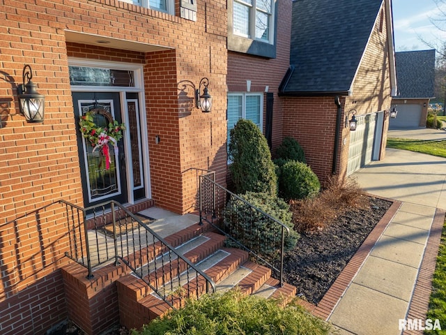 doorway to property featuring brick siding and roof with shingles