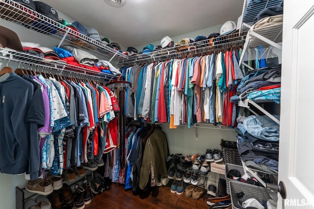 walk in closet with wood finished floors
