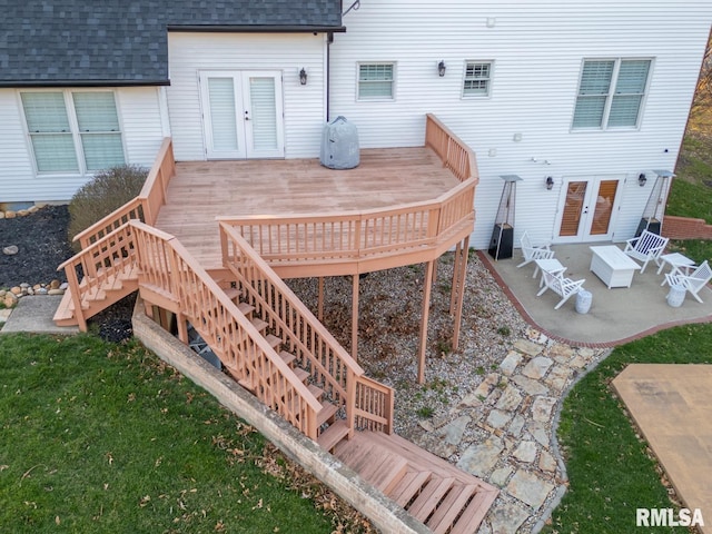 deck with stairs, a patio, french doors, and a lawn