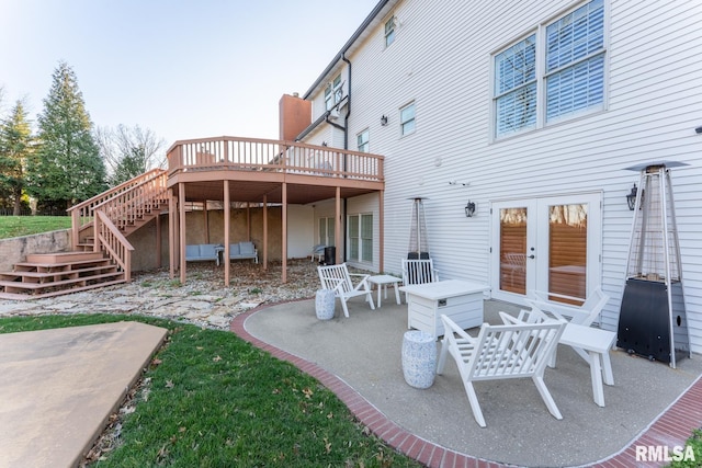 view of patio / terrace with french doors, a deck, and stairs