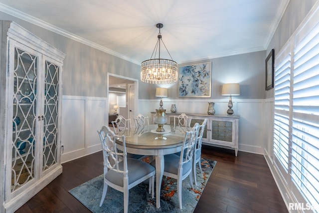 dining space featuring a wainscoted wall, crown molding, an inviting chandelier, and hardwood / wood-style flooring