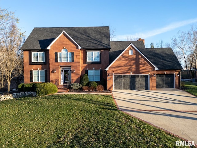 colonial-style house with brick siding, concrete driveway, a front yard, a chimney, and a garage