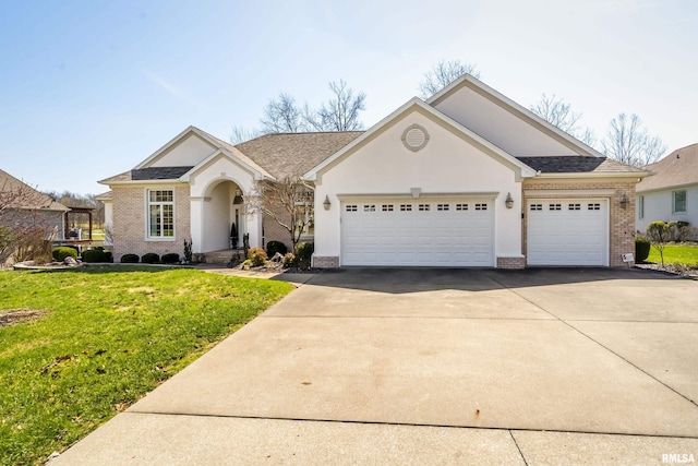 view of front facade featuring brick siding, driveway, a front yard, and an attached garage