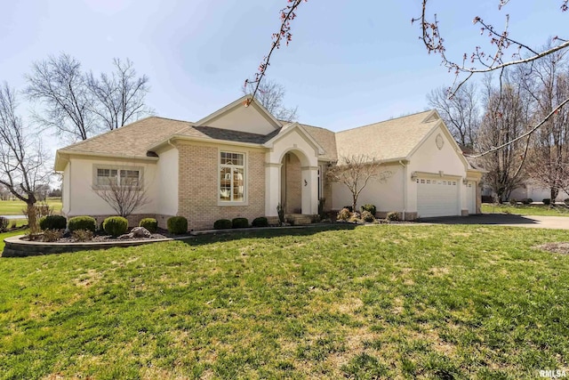 ranch-style home with a front lawn, aphalt driveway, roof with shingles, an attached garage, and brick siding