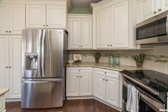kitchen with decorative backsplash, dark wood-type flooring, light stone counters, and appliances with stainless steel finishes