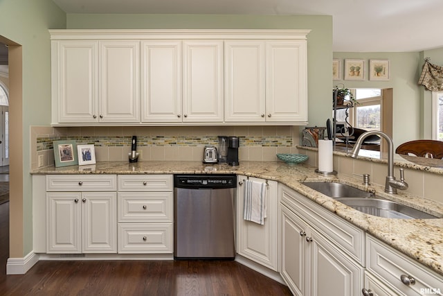 kitchen with dark wood-style flooring, dishwasher, decorative backsplash, and a sink