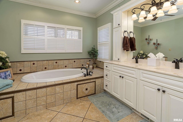 bathroom featuring tile patterned floors, crown molding, a garden tub, and a sink