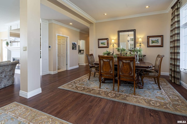 dining area featuring crown molding, baseboards, and wood finished floors