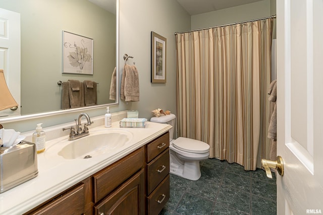 bathroom featuring curtained shower, toilet, and vanity