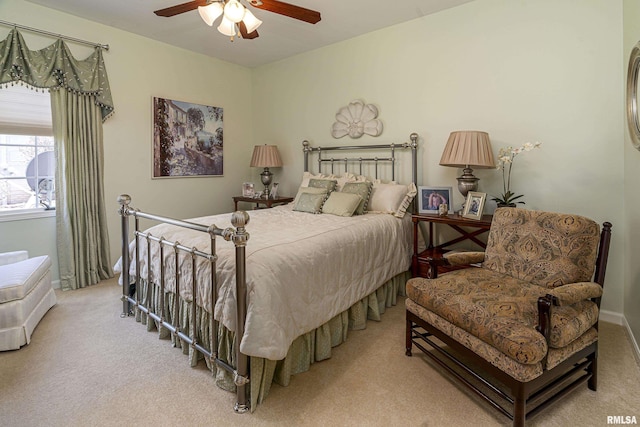 bedroom featuring light colored carpet and a ceiling fan