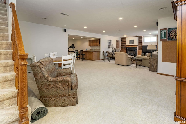living room with visible vents, stairs, light carpet, recessed lighting, and a fireplace