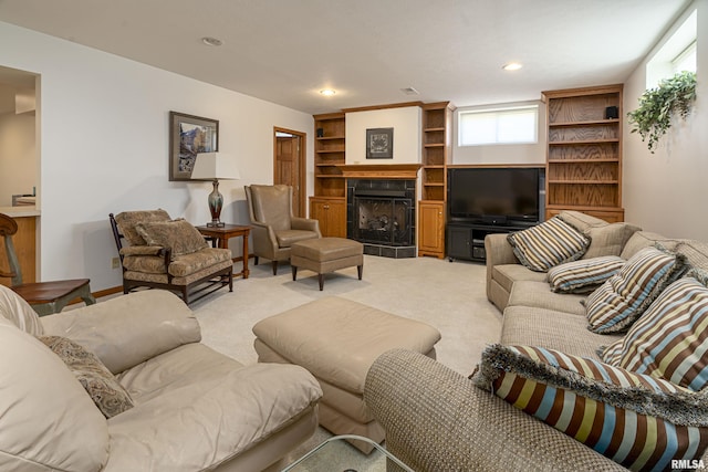 living room featuring a fireplace, recessed lighting, and light colored carpet