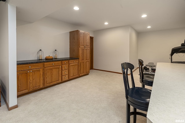 interior space with recessed lighting, light colored carpet, and baseboards