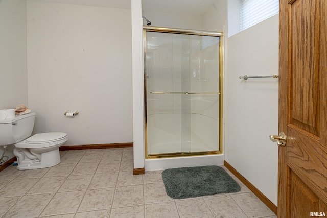 full bathroom with baseboards, toilet, a shower stall, and tile patterned flooring