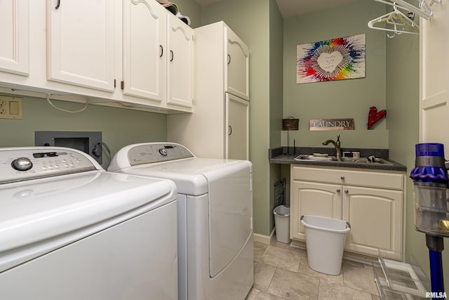 laundry area with a sink, cabinet space, and washer and clothes dryer