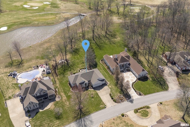 birds eye view of property featuring view of golf course and a water view
