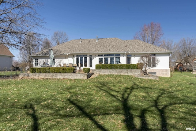 rear view of property with a yard, a patio, and stucco siding
