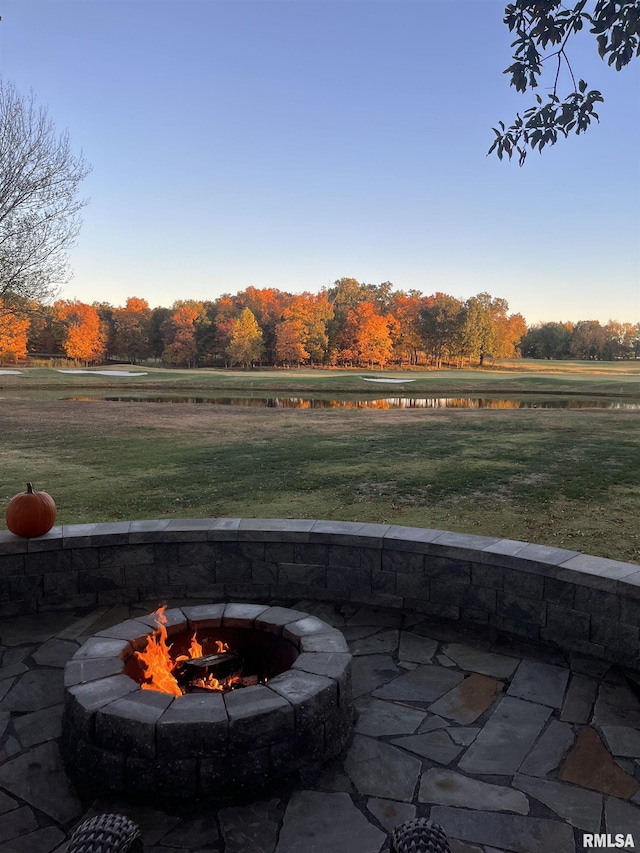 view of patio / terrace with a water view and an outdoor fire pit