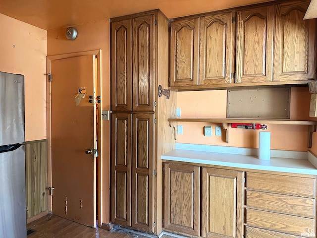 607 S Skyline Dr, Carbondale, IL 62901 - kitchen with visible vents, dark wood-style flooring, freestanding refrigerator, light countertops, and brown cabinets
