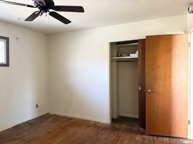 607 S Skyline Dr, Carbondale, IL 62901 - unfurnished bedroom with a closet, wood finished floors, and a ceiling fan