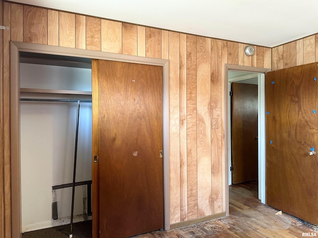 607 S Skyline Dr, Carbondale, IL 62901 - unfurnished bedroom with a closet, wooden walls, and wood finished floors