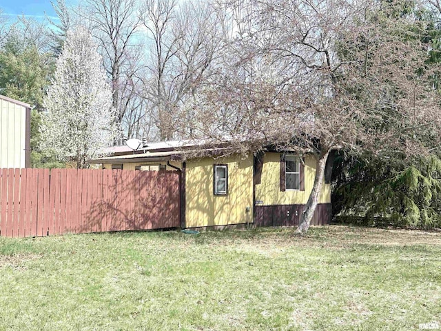 exterior space featuring a yard and fence