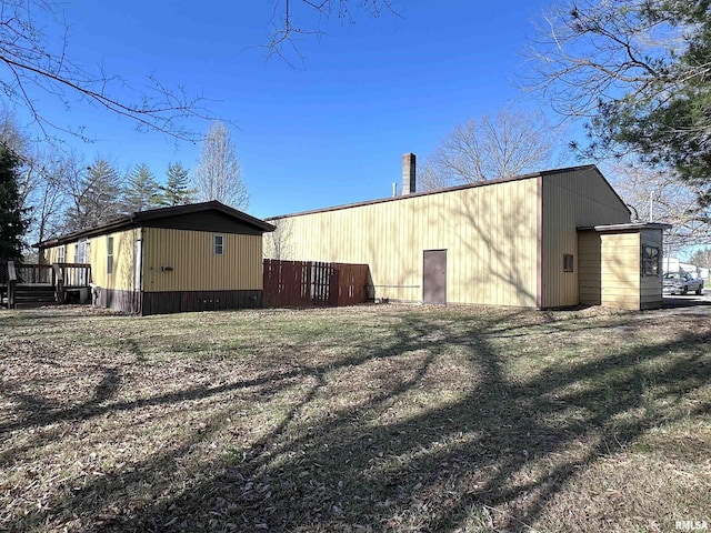 exterior space featuring a deck, an outdoor structure, and a pole building