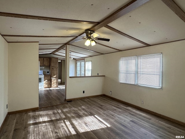 spare room featuring vaulted ceiling with beams, wood finished floors, baseboards, and ceiling fan