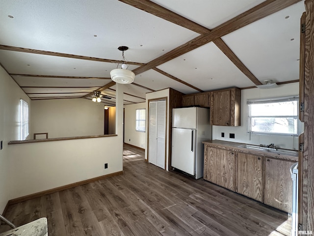 kitchen featuring lofted ceiling with beams, dark wood-style floors, white appliances, baseboards, and ceiling fan