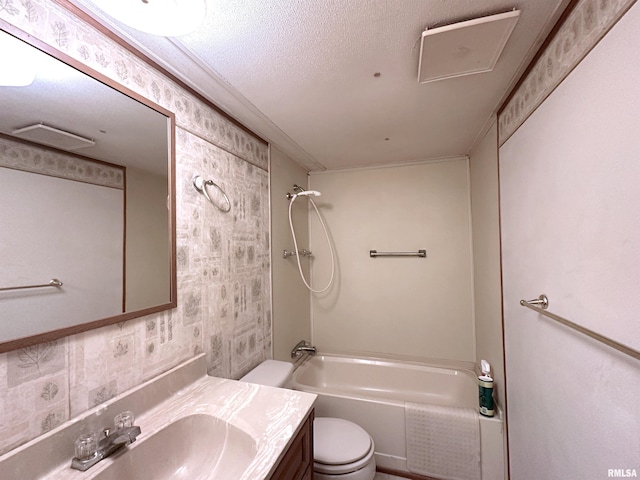 bathroom featuring wallpapered walls, toilet, shower / tub combination, a textured ceiling, and vanity