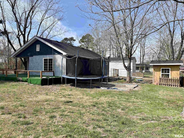 710 S Maple St, Cambria, IL 62915 - view of yard featuring a deck, a trampoline, an outdoor structure, and a storage shed