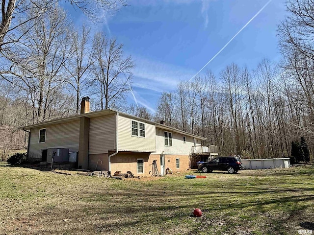 6180 Reevesville Rd, Grantsburg, IL 62943 - back of property with a chimney and a yard