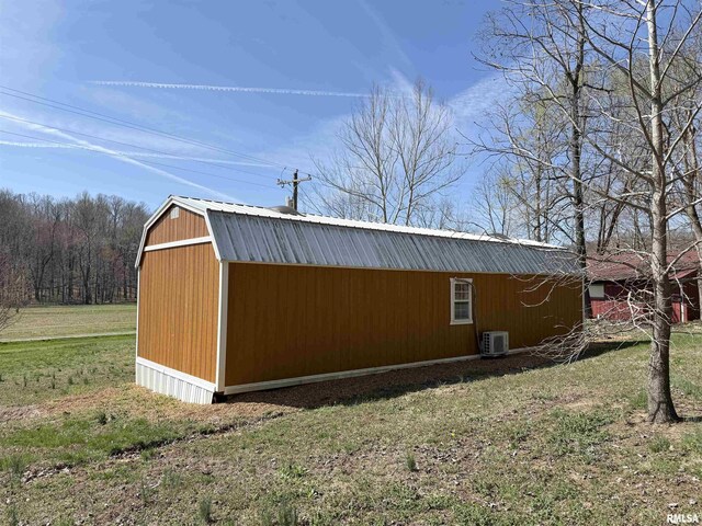 6180 Reevesville Rd, Grantsburg, IL 62943 - view of side of home featuring a lawn, a cooling unit, metal roof, and a gambrel roof