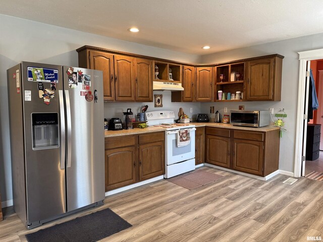 6180 Reevesville Rd, Grantsburg, IL 62943 - kitchen featuring appliances with stainless steel finishes, open shelves, under cabinet range hood, light countertops, and light wood-type flooring