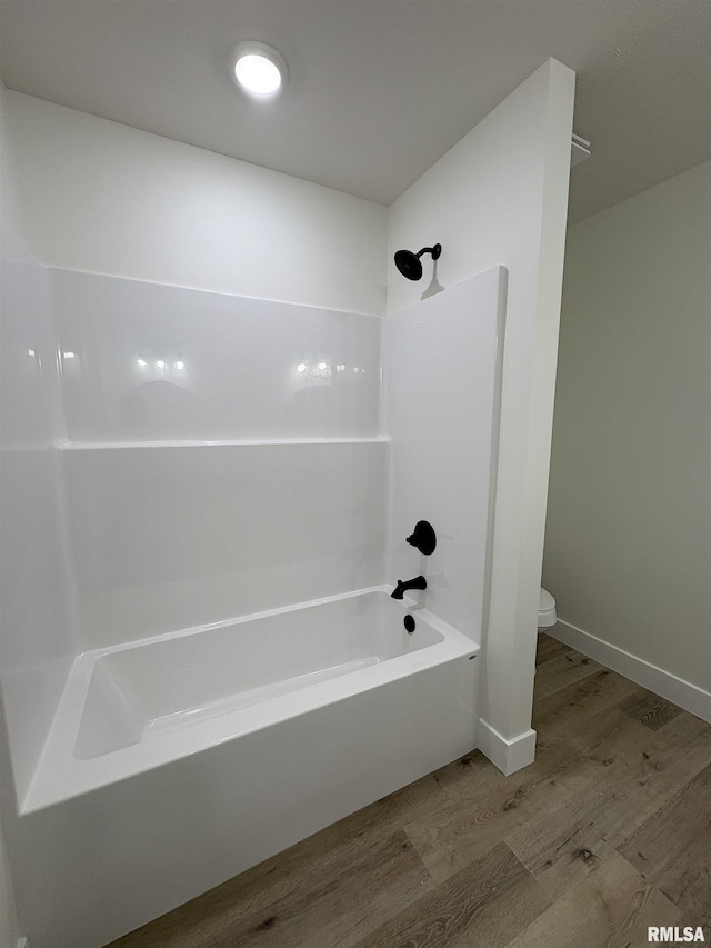 209 Madison St, Cambria, IL 62915 - bathroom with wood finished floors, toilet,  shower combination, and baseboards