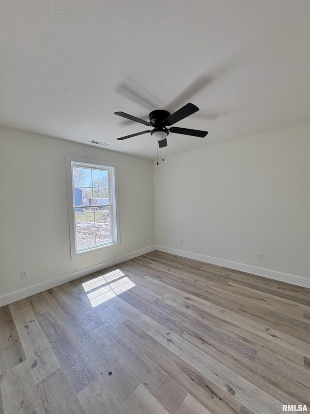 209 Madison St, Cambria, IL 62915 - spare room featuring ceiling fan, wood finished floors, and baseboards